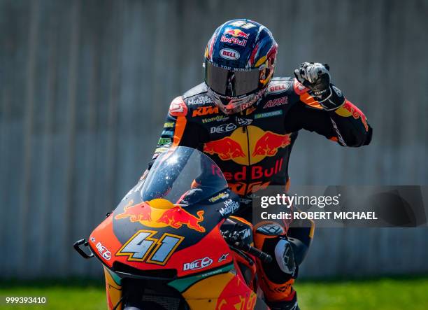 South African Red Bull KTM rider Brad Binder celebrates after winning the Moto2 race at the Grand Prix of Germany at the Sachsenring Circuit on July...