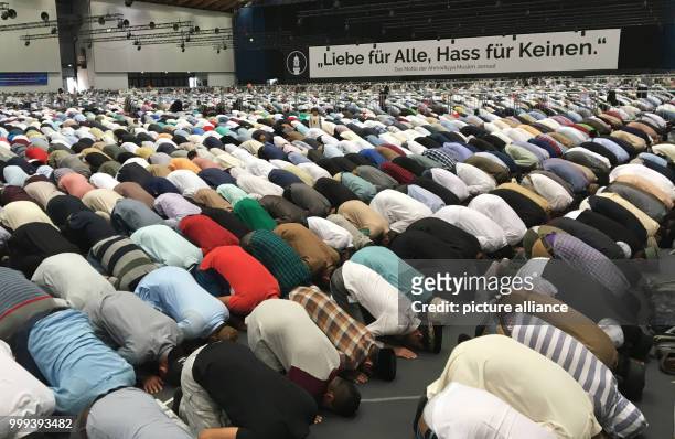 Muslims are praying and listening to the sermon at annual general meeting of the Ahmadiyya Muslim Jamaat in Rheinstetten, Germany, 25 August 2017....
