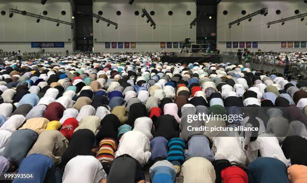 Muslims are praying and listening to the sermon at annual general meeting of the Ahmadiyya Muslim Jamaat in Rheinstetten, Germany, 25 August 2017....