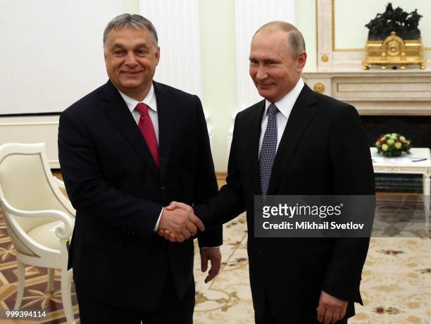 Russian President Vladimir Putin greets Hungarian Prime Minister Viktor Orban during their talks at the Kremlin, in Moscow, Russia, July 2018. Orban...