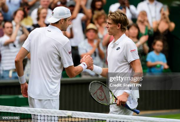 Kevin Anderson of South Africa commiserates with John Isner of the United States after beating him in the semi final of the gentlemen's singles at...