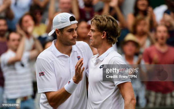 Kevin Anderson of South Africa commiserates with John Isner of the United States after beating him in the semi final of the gentlemen's singles at...