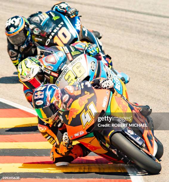 South African Red Bull KTM rider Brad Binder competes ahead of Spanish Kalex Rider Joan Mir and Italian Kalex rider Luca Marini during the Moto2 race...