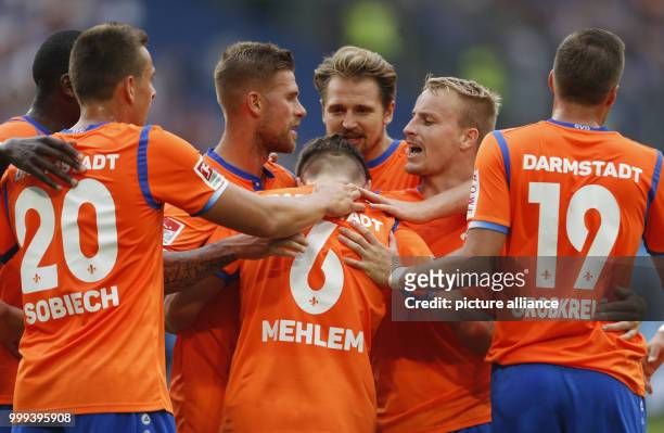Darmstadt's Marvin Mehlem celebrates the equaliser goal with his teammates during the German 2nd Bundesliga soccer match between MSV Duisburg and...