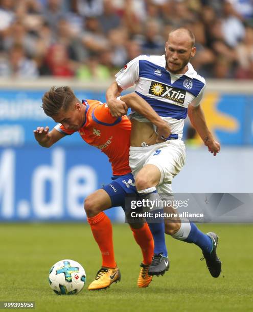 Duisburg's Gerrit Nauber and Darmstadt's Marvin Mehlem vie for the ball during the German 2nd Bundesliga soccer match between MSV Duisburg and...