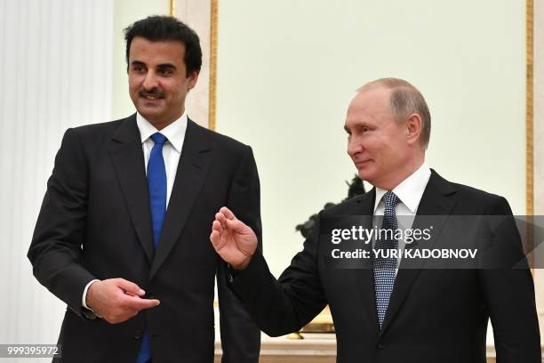 Emir of Qatar Sheikh Tamim bin Hamad Al-Thani speaks with Russian President Vladimir Putin during their meeting at the Kremlin in Moscow on July 15,...