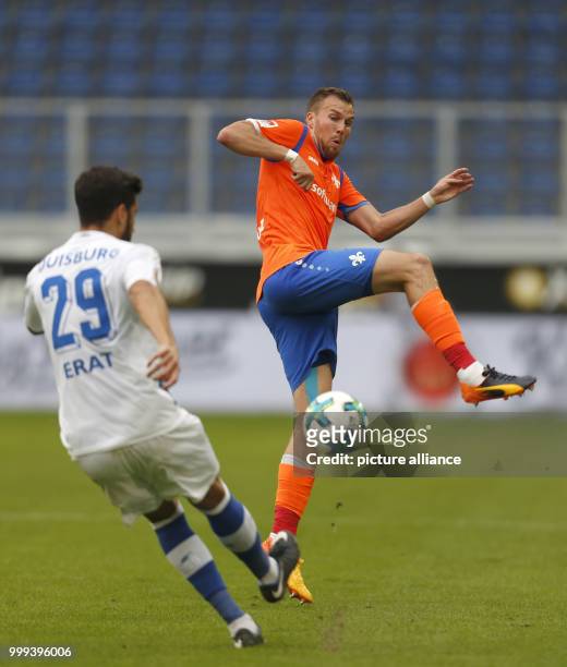 Darmstadt's Kevin Grosskreutz and Duisburg's Tugrul Erat vie for the ball during the German 2nd Bundesliga soccer match between MSV Duisburg and...