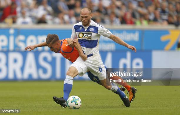 Duisburg's Gerrit Nauber and Darmstadt's Marvin Mehlem vie for the ball during the German 2nd Bundesliga soccer match between MSV Duisburg and...