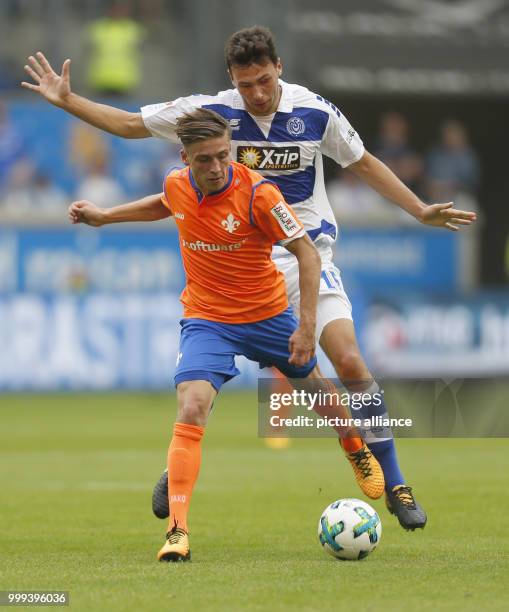 Duisburg's Lukas Froede and Darmstadt's Marvin Mehlem vie for the ball during the German 2nd Bundesliga soccer match between MSV Duisburg and...