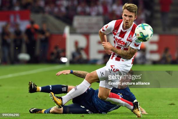 Cologne's Jannes Horn and Hamburg's Andre Hahn vie for the ball during the German Bundesliga soccer match between 1. FC Cologne and Hamburger SV in...