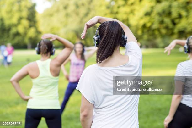 Participants of the Silent Zumba class of Pio Suh and his wife Ramona in action during a dancing class at a park in Munich, Germany, 15 August 2017....