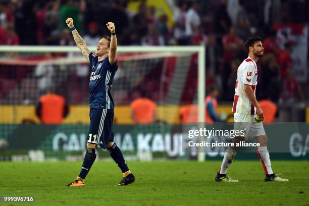 Hamburg's Andre Hahn celebrates the 1:3 victory over Cologne next to Cologne's Jonas Hector after the German Bundesliga soccer match between...