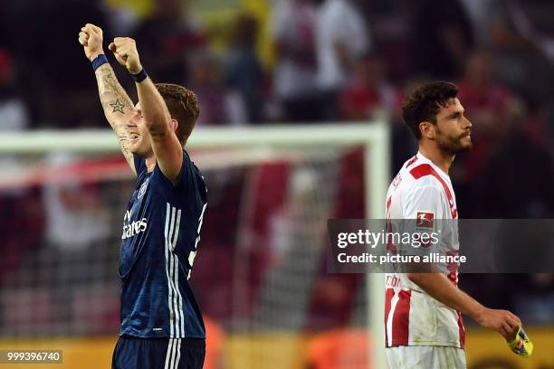 Hamburg's Andre Hahn celebrates the 1:3 victory next to Cologne's Jonas Hector after the German Bundesliga soccer match between 1. FC Cologne and...