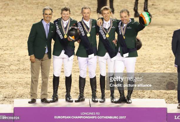 The show jumpers from Ireland with head of Equipe Rodrigo Pessoa , Shane Sweetnam, Denis Lynch, Bertram Allen and Cian O'Connor stand on the podium...