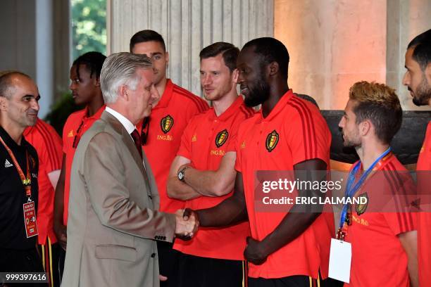 King Philippe - Filip of Belgium shakes hands with Belgian's forward Romelu Lukaku, accompanied with Belgium's head coach Roberto Martinez and team...