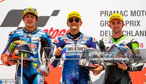 Second placed Italian KTM rider Marco Bezzecchi, winner Spanish Honda rider Jorge Martin and third placed Great Britain KTM rider John Mcphee stand...