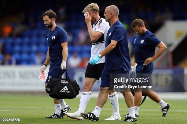 Tim Ream of Fulham leaves the pitch injured during the pre-season friendly between Reading and Fulham at the EBB Stadium on July 14, 2018 in...