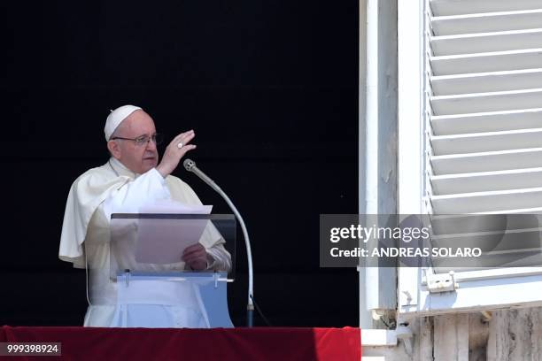 Pope Francis blesses the crowd from the window of the apostolic palace overlooking St Peter's square during the Sunday Angelus prayer, on July 15,...