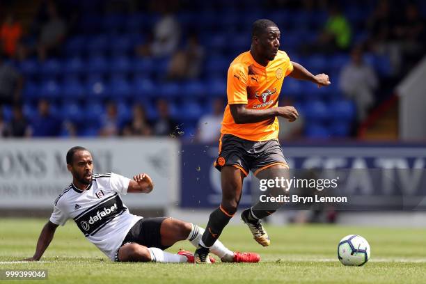 Yakou Meite of Reading is tackled by Ryan Sessegnon of Fulham during the pre-season friendly between Reading and Fulham at the EBB Stadium on July...