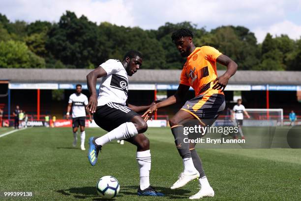 Aboubakar Kamara of Fulham is challenged by Tyler Blackett of Reading during the pre-season friendly between Reading and Fulham at the EBB Stadium on...