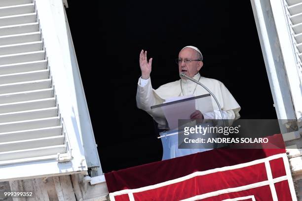 Pope Francis blesses the crowd from the window of the apostolic palace overlooking St Peter's square during the Sunday Angelus prayer, on July 15,...