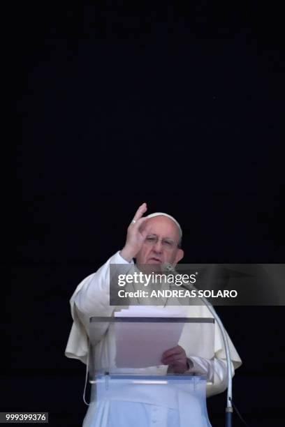 Pope Francis blesses the crowd from the window of the apostolic palace overlooking St Peter's square during the Sunday Angelus prayer, on July 15,...