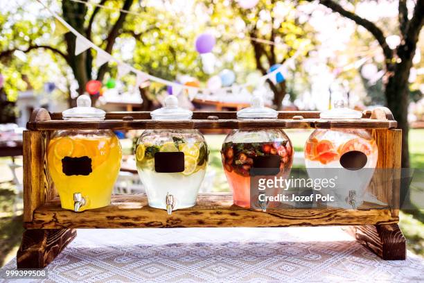 jars with a tap on a wooden stand in a garden. - jozef polc stock pictures, royalty-free photos & images