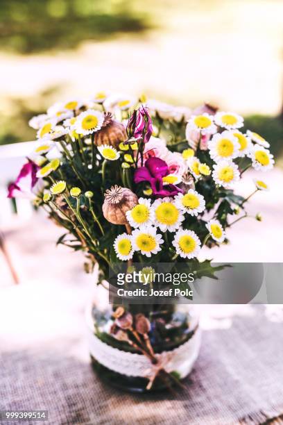 flowers in the vase on the table in the garden. - jozef polc stock pictures, royalty-free photos & images