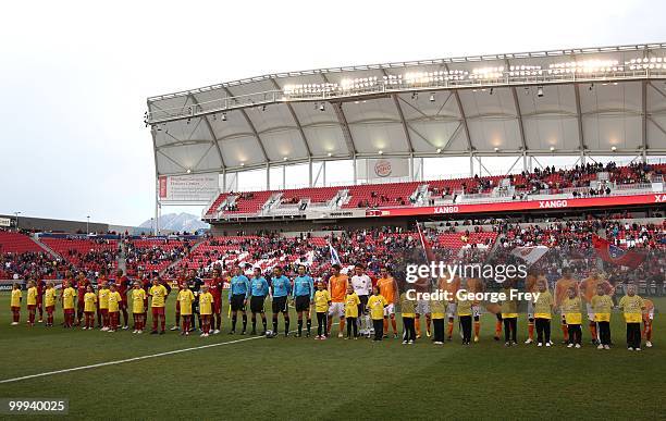 Players stand for the National Anthem before the start of the MLS soccer game between the Houston Dynamo and Real Salt Lake on May 13, 2010 in Sandy,...