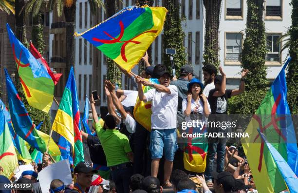 Moroccan demonstrators shout slogans as they wave the Berber, or Amazigh, flag during a protest march against the jailing of Al-Hirak al-Shaabi or...