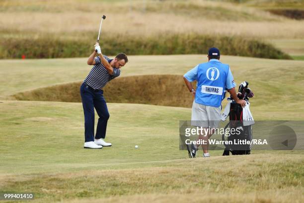 Justin Thomas of the United States plays his second shot at the 3rd hole while practicing during previews to the 147th Open Championship at...