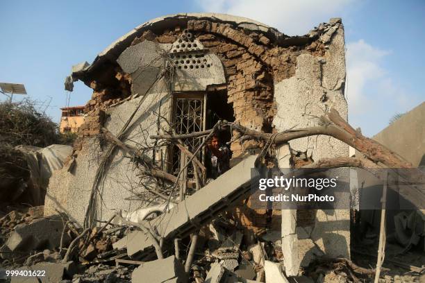 Palestinian man inspects the arts and handcraft village that was damaged by Israeli air strikes in Gaza City July 15, 2018.