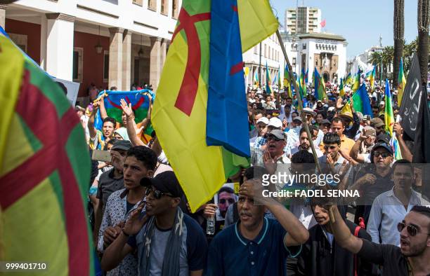 Moroccan demonstrators shout slogans as they wave the Berber, or Amazigh, flag during a protest march against the jailing of Al-Hirak al-Shaabi or...