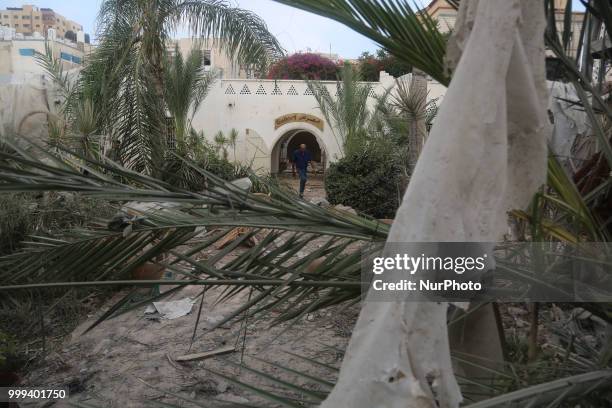 Palestinian man inspects the arts and handcraft village that was damaged by Israeli air strikes in Gaza City July 15, 2018.