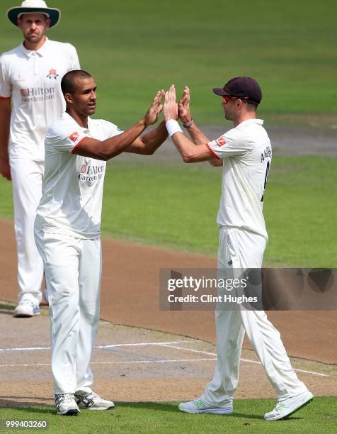 Liam Hurt of Lancashire celebrates with team-mate James Anderson after taking the wicket of Tom Keast of Nottinghamshire during the Lancashire Second...