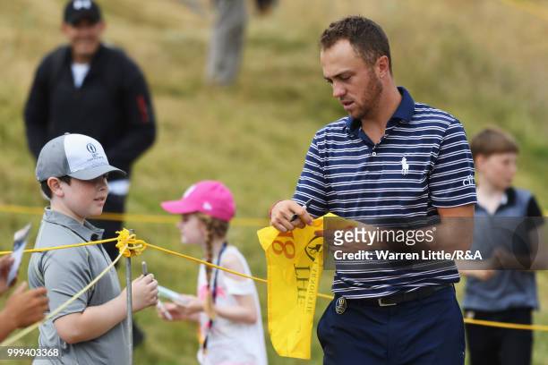 Justin Thomas of the United States signs autographs for fans while on a practice round during previews to the 147th Open Championship at Carnoustie...