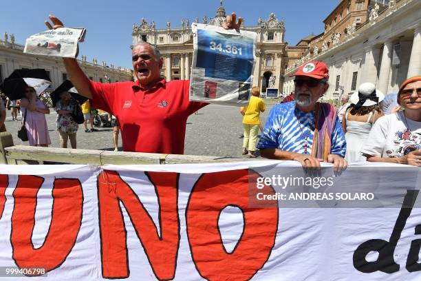 Italian priests demonstrate in front of the St Peter Basilica with a banner reading "Fasting of justice in solidarity with migrants" as they attend...