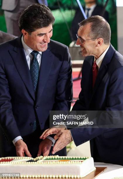 Dominique Mas , the French Consul General in Arbil, and Nechirvan Barzani, Prime Minister of Iraq's Kurdistan Regional Government, carve a cake as...