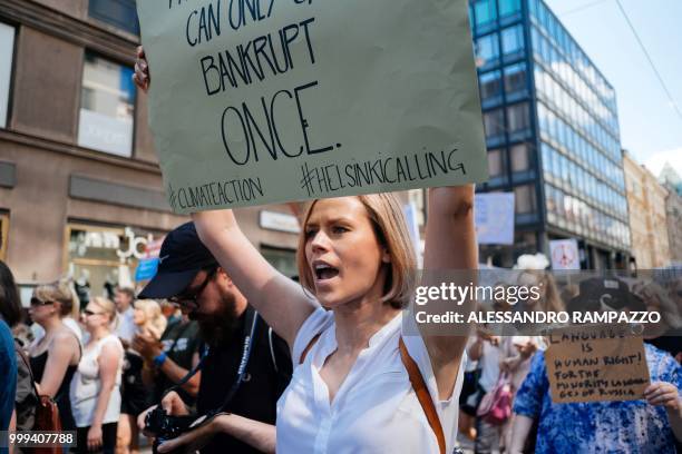 Protester holds a placard during the so-called "Helsinki Calling" march towards the Senate Square to defend the human rights, freedom of speech and...