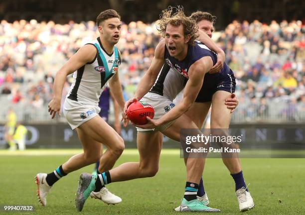 David Mundy of the Dockers looks to handball during the round 17 AFL match between the Fremantle Dockers and the Port Adelaide Power at Optus Stadium...