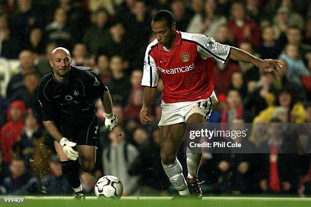 Thierry Henry of Arsenal beats Manchester Keeper Fabien Barthez during the FA Barclaycard Premiership match between Arsenal and Manchester United at...