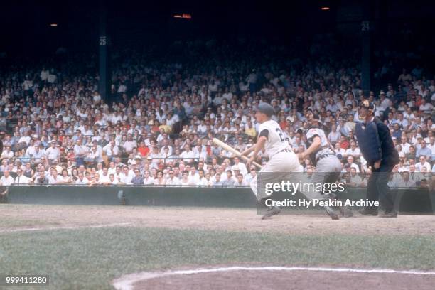 Paul Foytack of the Detroit Tigers gets the bunt down as catcher Dick Brown of the Cleveland Indians and umpire Bill McKinley look on during an MLB...