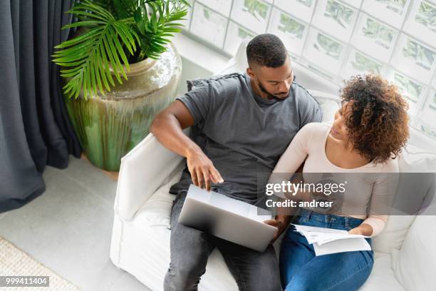 african american couple paying bills online at home - french budget stock pictures, royalty-free photos & images