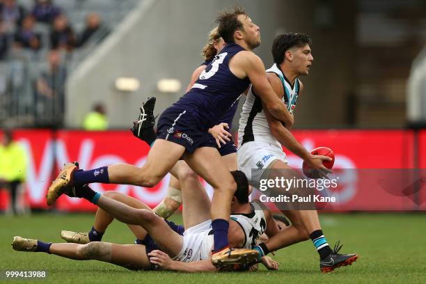 Cameron Sutcliffe of the Dockers tackles Riley Bonner of the Power during the round 17 AFL match between the Fremantle Dockers and the Port Adelaide...