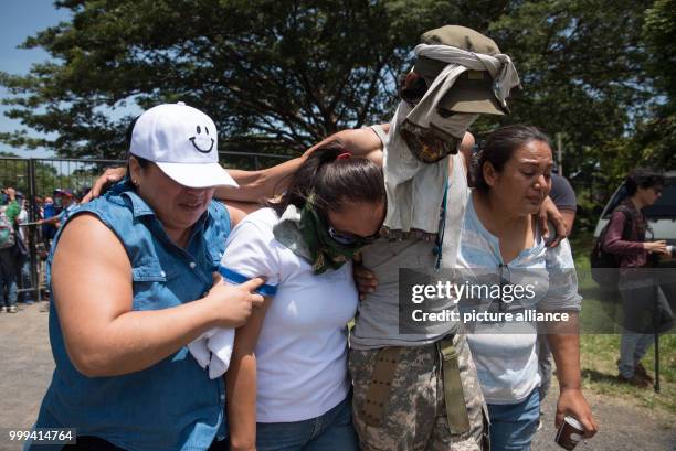July 2018, Nicaragua, Managua: A student hugs his family upon his arrival at the Nicaraguan Cathedral. During the siege of a church in Nicaragua,...