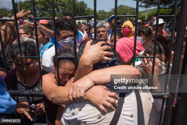 Dpatop - 14 July 2018, Nicaragua, Managua: A student hugs his family upon his arrival at the Nicaraguan Cathedral. During the siege of a church in...