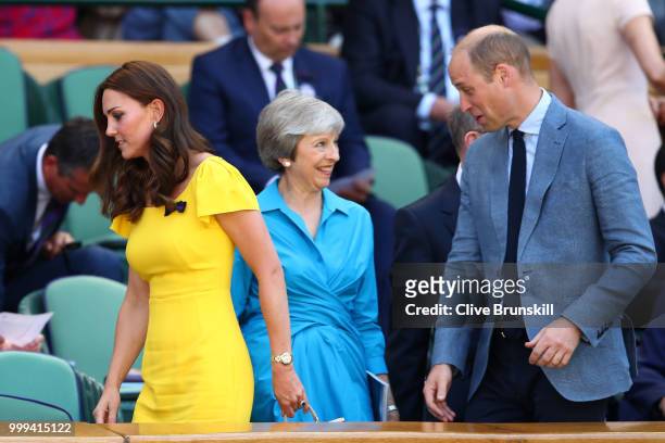Catherine, Duchess of Cambridge and Prince William, Duke of Cambridge pass British Prime Minister Theresa May as they attend the Men's Singles final...