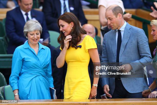 Catherine, Duchess of Cambridge and Prince William, Duke of Cambridge pass British Prime Minister Theresa May as they attend the Men's Singles final...