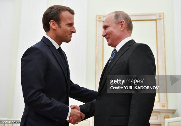 Russian President Vladimir Putin shakes hands with French President Emmanuel Macron during their meeting at the Kremlin in Moscow on July 15, 2018.