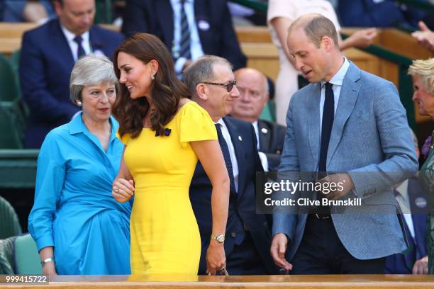 Catherine, Duchess of Cambridge and Prince William, Duke of Cambridge pass British Prime Minister Theresa May and her husband Philip May as they...